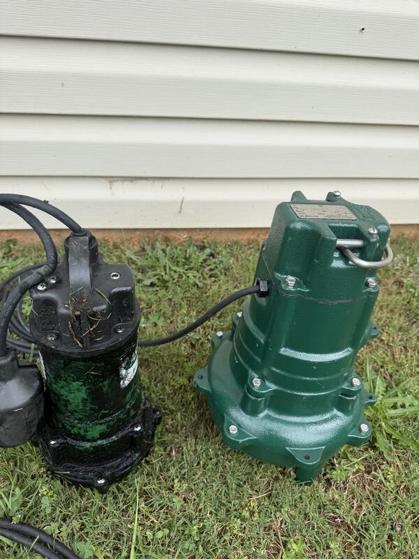 Failed sewage pump next to its replacement unit before installation